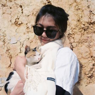 Woman in Sunglasses Holding Cat