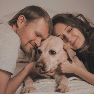 Woman and Man Lying Down with Dog